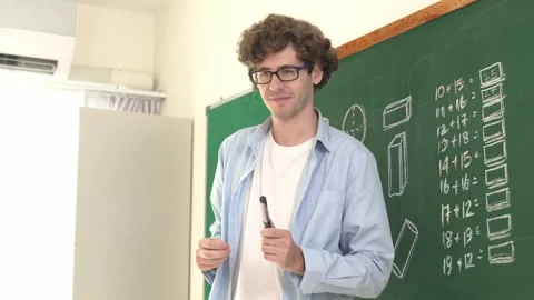 Caucasian teacher looking at student while standing at blackboard. Pedagogy. Stock Footage 268485801