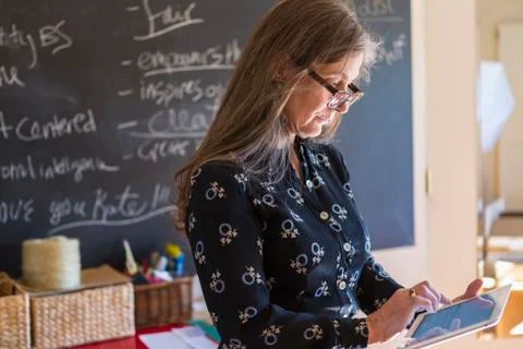 Caucasian teacher using digital tablet in classroom 스톡 사진