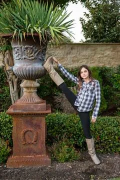 Caucasian teenage girl stretching leg in backyard Stock Photos