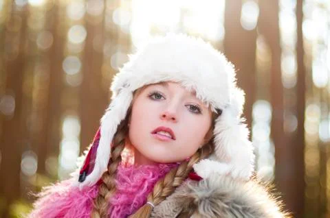 Caucasian teenage girl wearing fuzzy hat outdoors Stock Photos