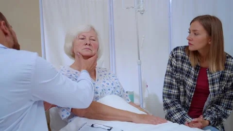 Caucasian therapist checking thyroid glands of older woman saying good results Stock Footage 143022409