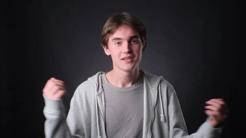 Caucasian Vlogger Engaging with Camera on black Background 库存影片 257452146