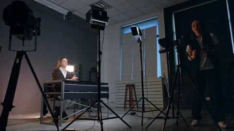 Caucasian woman checking a camera directed on the lady sitting at desk Video stock 312761799