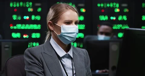 Caucasian woman IT programer working on desktop computers in data center control Stock Footage 144409168