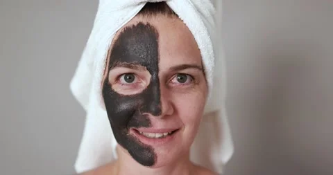 Caucasian woman looking on camera while doing skin care Video stock 157005187