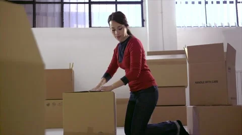 Caucasian woman moving to new apartment with boxes Stock Footage