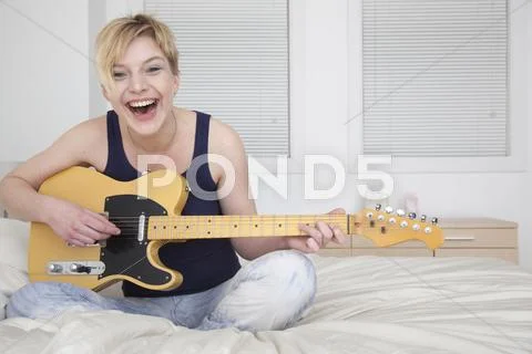 Caucasian woman playing electric guitar Stock Photos