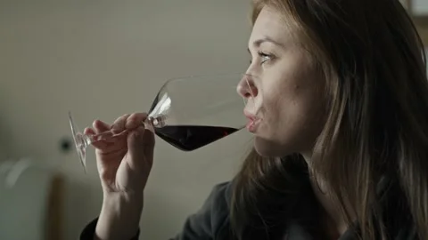 Caucasian woman with problems drinking red wine at home Stock Footage 220409135