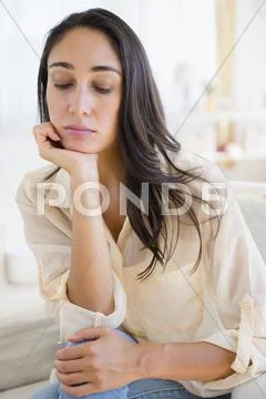 Caucasian woman resting chin in hand Stock Photos