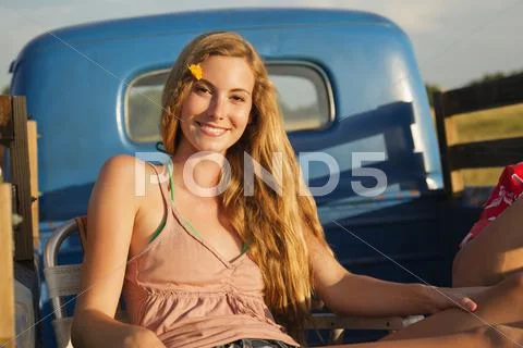 Caucasian Woman Sitting In Back Of Truck