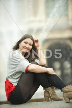 Caucasian Woman Sitting Near Fountain