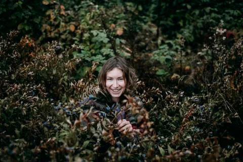 Caucasian woman smiling in bush Stock Photos