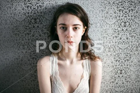 Caucasian woman standing at wallpaper Stock Photos