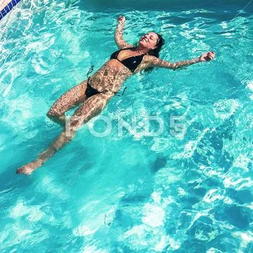 Caucasian Woman Swimming In Swimming Pool