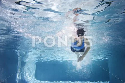 Caucasian Woman Swimming In Swimming Pool