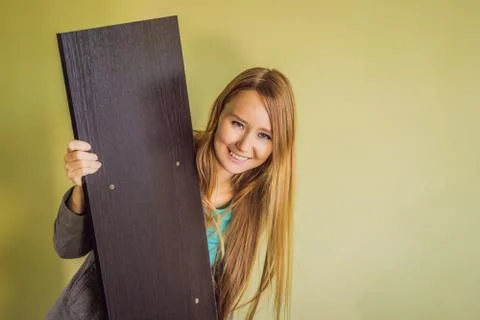 Caucasian woman using screwdriver for assembling furniture Stock Photos
