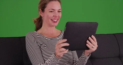 Caucasian woman using tablet to make video call on green screen Stock Footage