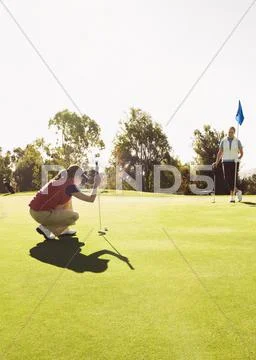Caucasian Women Playing Golf On Golf Course