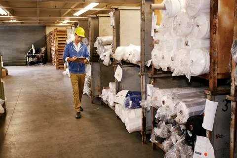 Caucasian worker checking product in warehouse Stock Photos