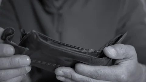 Caucasian worker with a missing finger opening  hes empty wallet Stock Footage 114348119