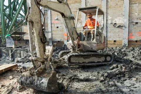 Caucasian worker using digger at construction site Stock Photos