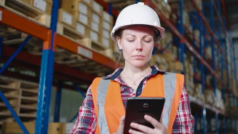 Caucasian worker using a tablet checking inventory in the warehouse Stock Footage 164237479