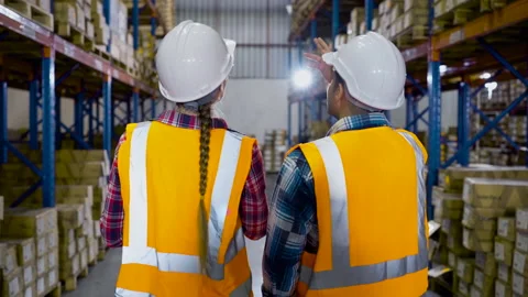 Caucasian workers inspecting inventory in the distribution warehouse Video stock 163345966