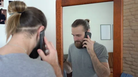 Caucasian young beard guy talking on smartphone  with new shirt Video stock 147894994