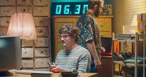 Caucasian young computer programist nerd in glasses sitting at vintage PC Video stock 135630540