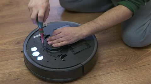 Caucasian young man doing vacuum cleaner robot Stock Footage 255227350