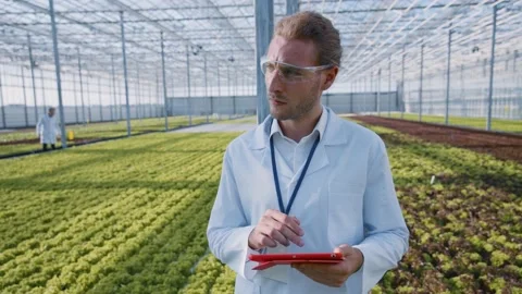 Caucasian young man lab worker using tablet computer programming actions for Video stock 139723544