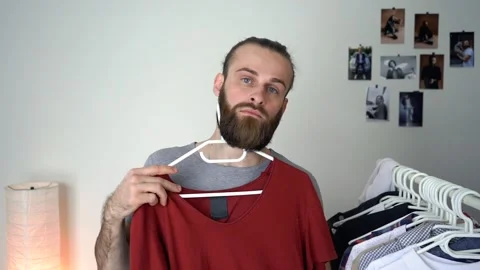 Caucasian young Man is looking into the mirror Putting together an outfit Stock Footage 147900196