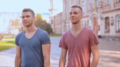 Caucasian young men walking in campus area Stock Footage 99867588