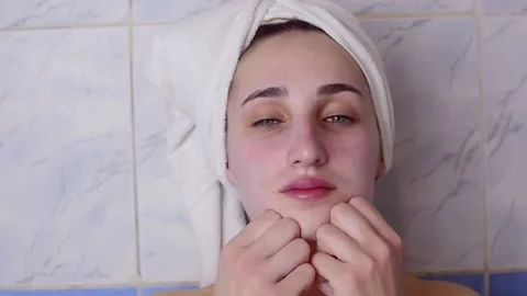 Caucasian young model without makeup, doing a facial massage using a Gua Sha sto 스톡 동영상 180496578