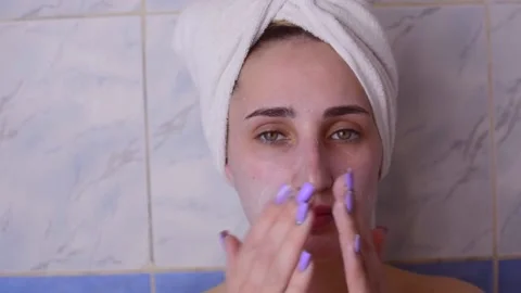 Caucasian young model without makeup, doing a facial massage using a Gua Sha sto Stock Footage 180496757