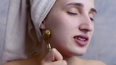 Caucasian young model without makeup, doing a facial massage using a Gua Sha sto Stock Footage 180499547