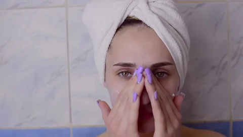 Caucasian young model without makeup, doing a facial massage using a Gua Sha sto Stock Footage 180499891