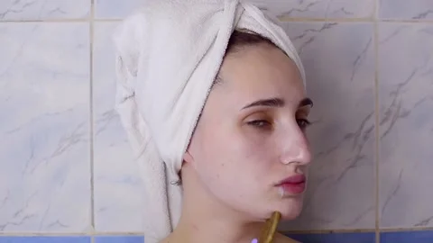 Caucasian young model without makeup, doing a facial massage using a Gua Sha sto Stock Footage 180499949