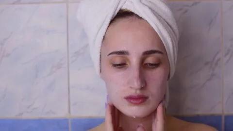 Caucasian young model without makeup, doing a facial massage using a Gua Sha sto Stock Footage 180500007
