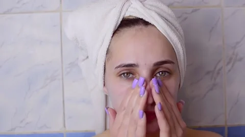 Caucasian young model without makeup, doing a facial massage using a Gua Sha sto Stock Footage 180500037