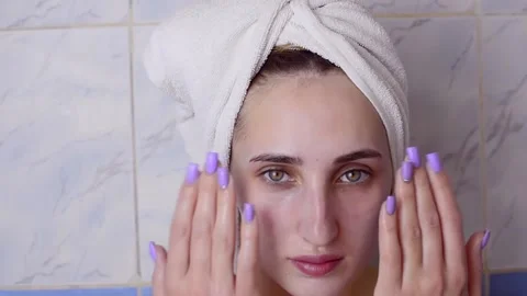 Caucasian young model without makeup, doing a facial massage using a Gua Sha sto Stock Footage 180500064