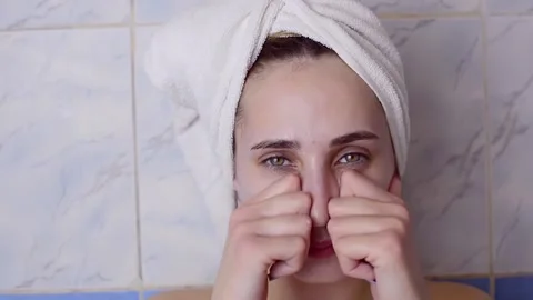 Caucasian young model without makeup, doing a facial massage using a Gua Sha sto Stock Footage 180500113