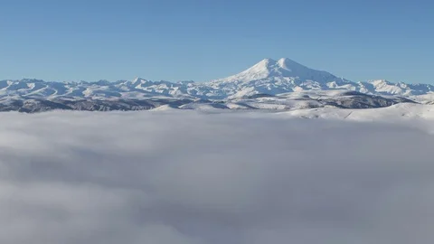 Caucasus. The formation of winter clouds above the volcano Elbrus Stock Footage 70409256