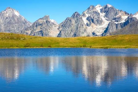 The Caucasus mountain range in the reflection of the mountain lake Stock Photos