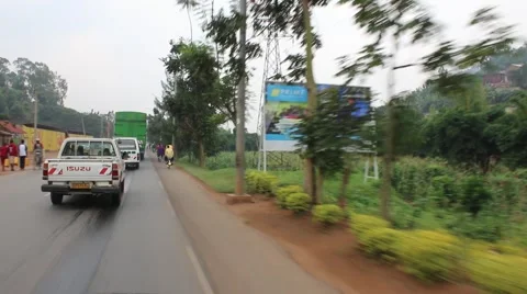 Caught behind line of trucks while driving through rwanda villages Stock Footage 47885290