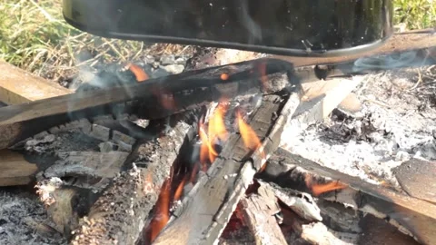 The cauldron is heated on a bonfire close-up Stock Footage 135238363