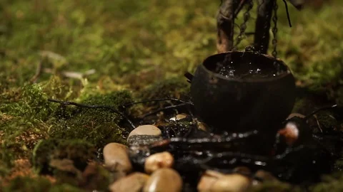 Cauldron over the fire with water bubbles Stock Footage 71604933