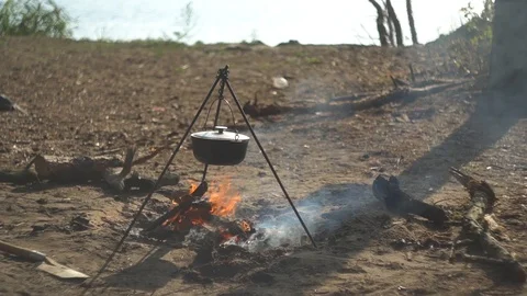 Cauldron at the stake. on the background of the river Stock Footage 113271431