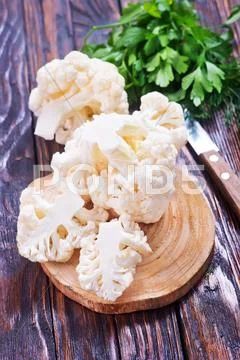 Cauliflower and knife on the wooden board Stock Photos