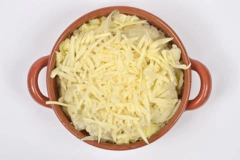 Cauliflower and mashed potatoes topped with grated cheese in a clay bowl Stock Photos